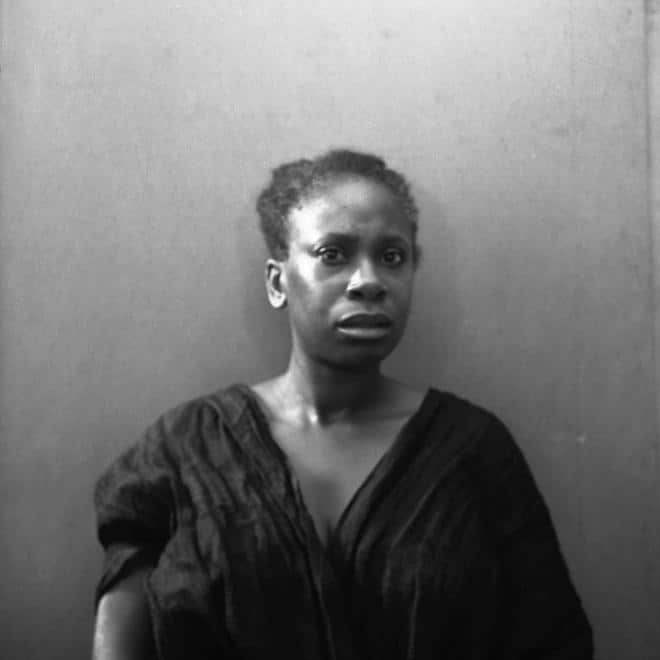 A photograph by Marcia Michael depicting a woman who looks startled looking at the camera